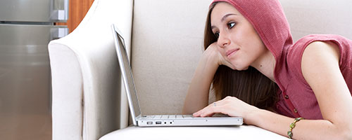 Young woman using NBN on laptop Young woman using NBN on laptop